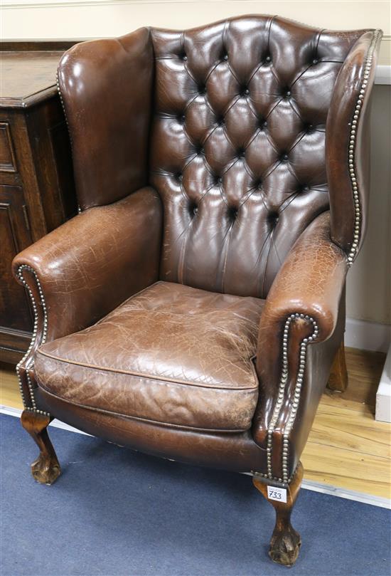 A pair of leather button back wing armchairs (a.f.)